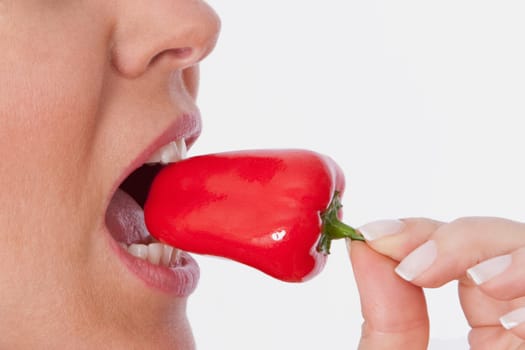 Close_up of a woman eating red bell pepper