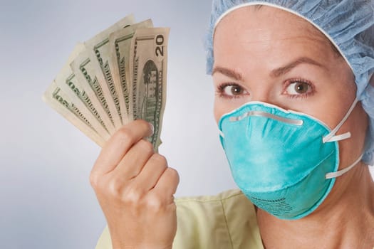 Female doctor holding currency notes