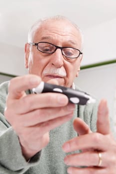 Man testing his blood sugar level