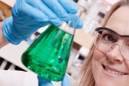 Female doctor holding a conical flask in a laboratory