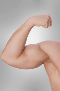 Close_up of a man showing biceps