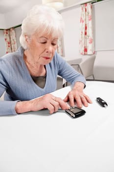 Woman testing her blood sugar level