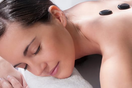 Woman receiving hot stone therapy