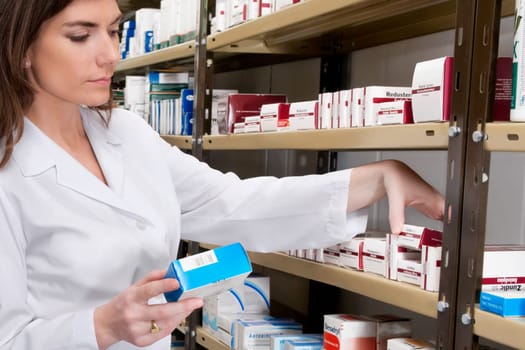 Female pharmacist checking the medicines in a medical store