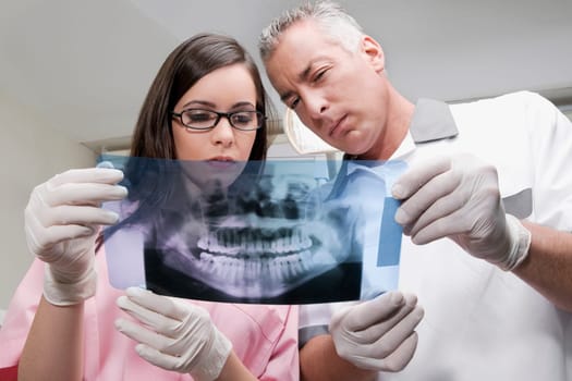 Two dentists examining an X_Ray report