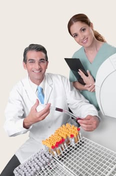 Lab technician filling blood in a test tube from a syringe