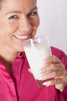 Close_up of a woman drinking milk from a glass