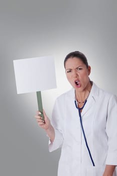 Female doctor holding a blank placard