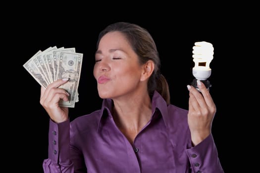Woman holding currency notes and a compact fluorescent light bulb