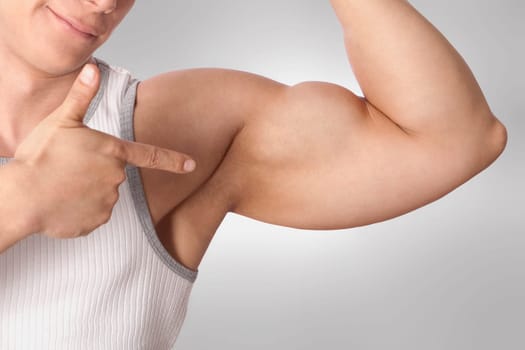 Close_up of a man showing biceps