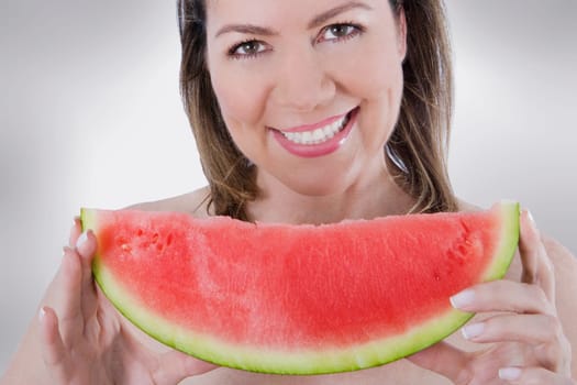 Woman holding a slice of watermelon