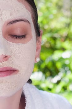 Woman with facial mask on her face