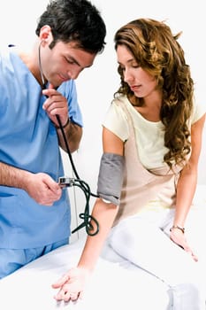 Doctor checking a womanŽs blood pressure