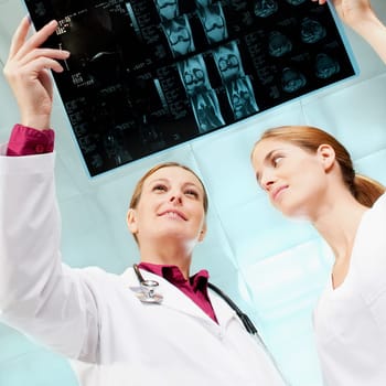 Female doctor and a nurse examining an X_Ray