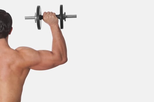 Rear view of a man exercising with a dumbbell