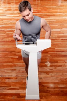 Man measuring his weight on a weighing scale