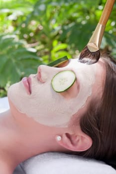 Woman applying a facial mask