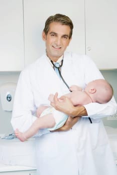 Doctor carrying a newborn baby