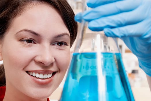 Female doctor holding a conical flask in a laboratory