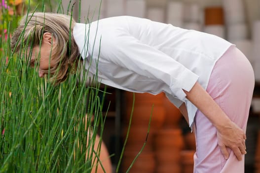 Woman looking at plants in a greenhouse