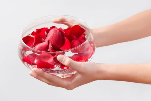Close_up of a womanŽs hands holding a bowl of rose petals