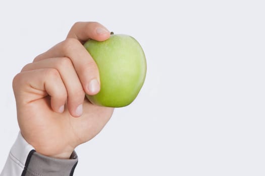 PersonŽs hand holding a green apple