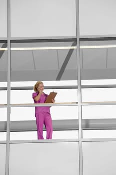 Female doctor talking on a mobile phone in a hospital