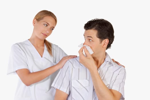Woman beside a man suffering from cold