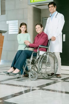 Doctor pushing a woman in a wheelchair