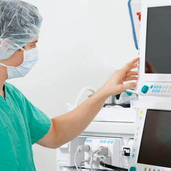 Doctor working on a cardiac monitor screen