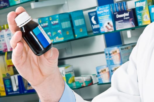Close_up of a pharmacistŽs hand holding a vial of medicine
