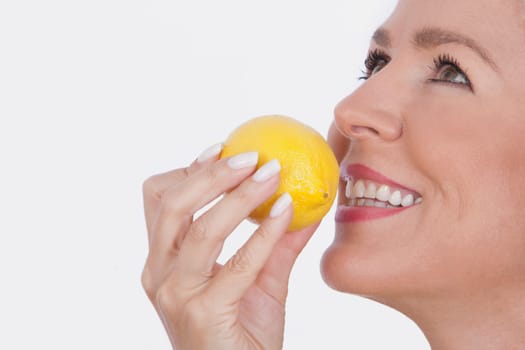 Woman smelling a lemon
