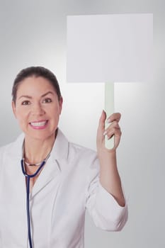 Female doctor holding a blank placard