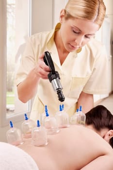 Woman receiving vacuum cupping treatment