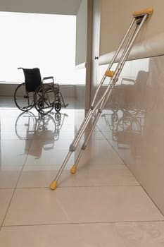 Wheelchair with a crutch in the corridor of a hospital