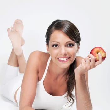 Woman holding a red apple and smiling