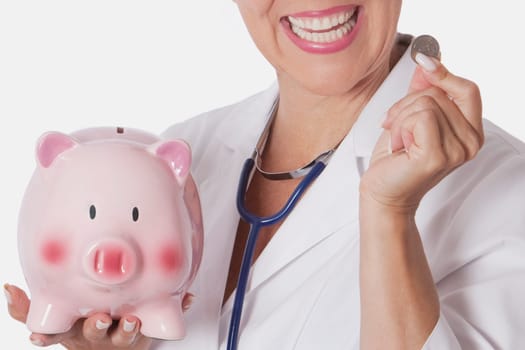 Female doctor holding a coin and a piggy bank