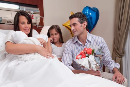 Couple with their newborn baby in a hospital