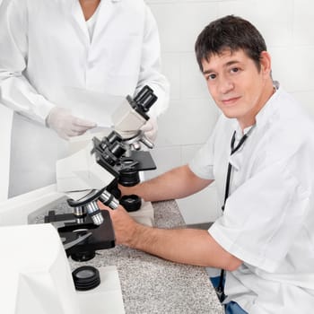 Vet looking into a microscope