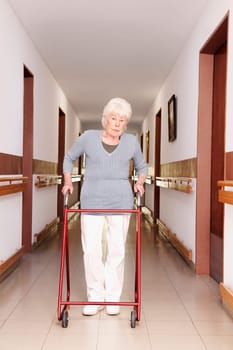Woman walking with the help of a walker