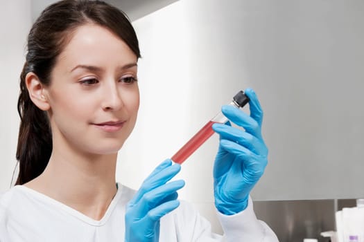 Female doctor holding a medical sample in a laboratory