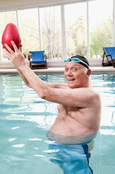 Man playing with a rugby ball in a swimming pool