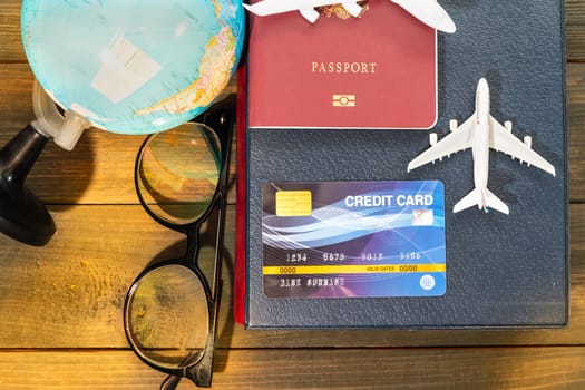 Credit card and airplane model on wooden table , Preparation for Traveling concept
