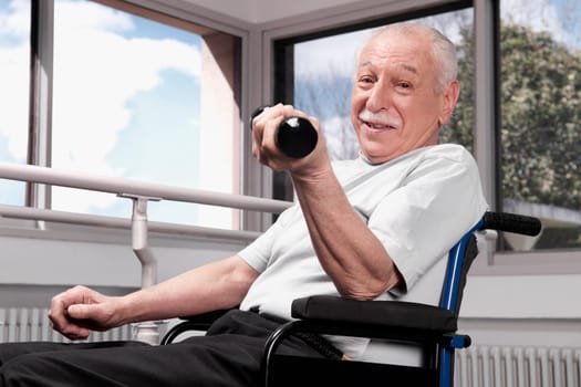 Disabled man exercising with dumbbells