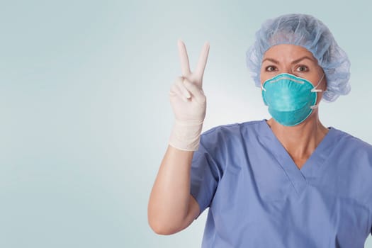 Female surgeon showing victory sign
