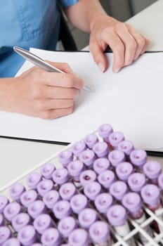 Female lab technician preparing a medical report