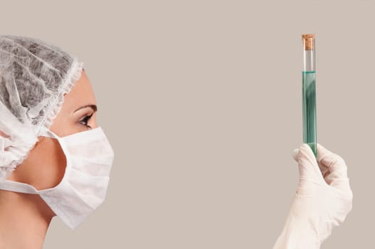 Female lab technician analyzing a sample in a test tube