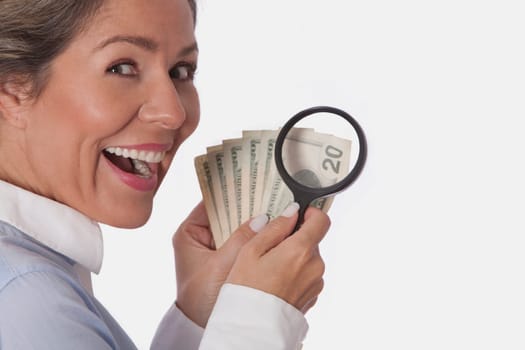 Woman examining currency notes with a magnifying glass