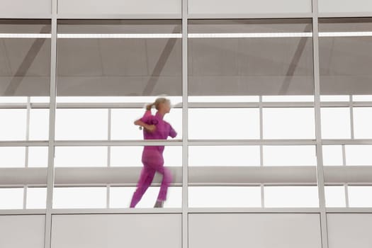 Female doctor running in a hospital corridor