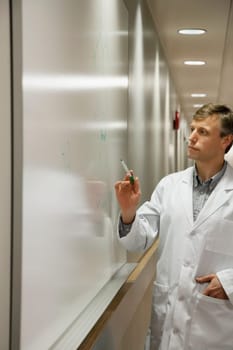 Doctor writing on a whiteboard in a hospital